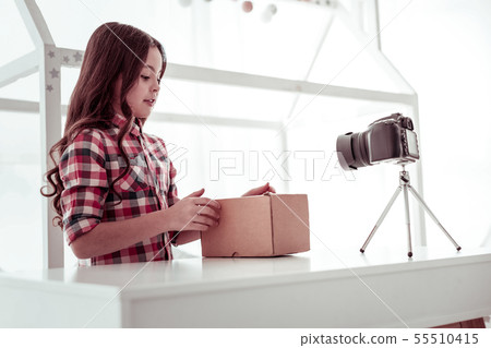 Nice smart girl standing in front of the box Nice smart girl standing in front of the box 55510415
