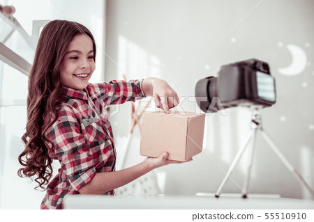 Cheerful happy girl pointing at the box 55510910