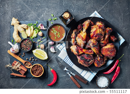 Grilled spicy Jerk Chicken drumsticks and thighs 55511117