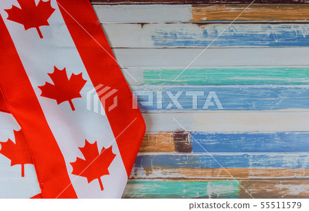 Canadian red and white flag against dark rustic Canadian red and white flag against dark rustic 55511579