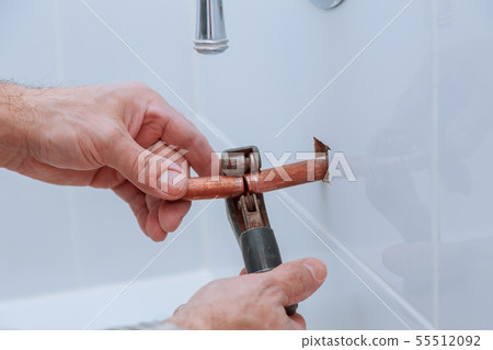 hand of working cutting copper pipe hand of working cutting copper pipe 55512092
