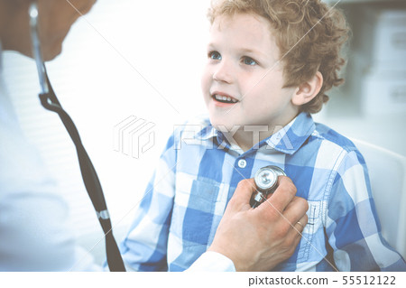 Doctor and patient child. Physician examining little boy. Regular medical visit in clinic. Medicine 55512122