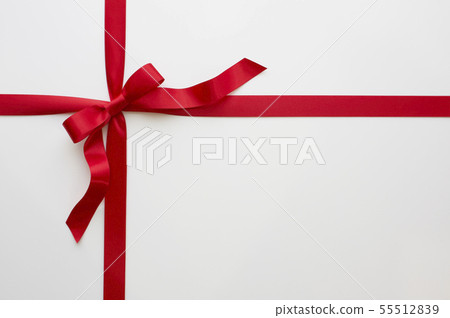 Red ribbon tied to a cross Red ribbon tied to a cross 55512839