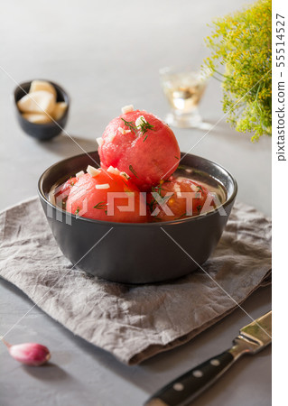 Marinated peeled tomatoes with garlic and dill. 55514527