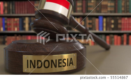 Flag of Indonesia on falling judges gavel in court. National justice or jurisdiction related 55514867