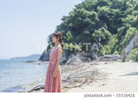 A woman relaxing at the sea 55516428