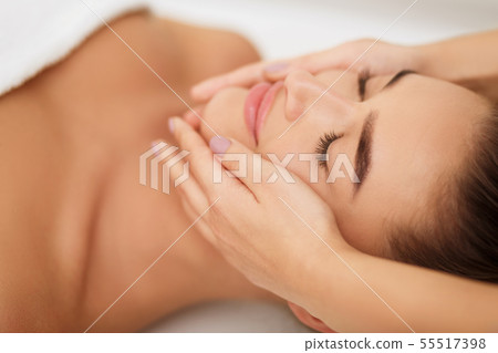 Woman getting face massage at beauty salon, closeup Woman getting face massage at beauty salon, closeup 55517398