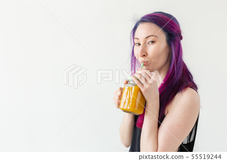 Portrait of a positive young mixed race and hipster girl with colored hair holding fruit protein Portrait of a positive young mixed race and hipster girl with colored hair holding fruit protein 55519244