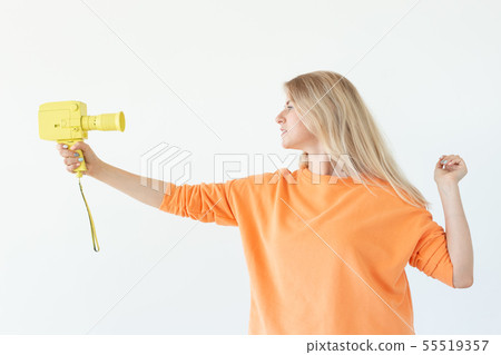 Photographing, emotions and vintage concept - surprised girl with retro camera over the white 55519357