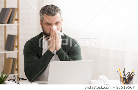 Caucasian man has runny nose, working from home Caucasian man has runny nose, working from home 55519567