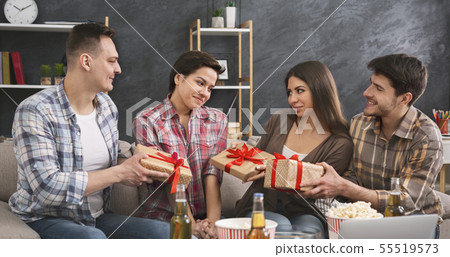 Friends presenting gifts to a girl celebrating her birthday 55519573