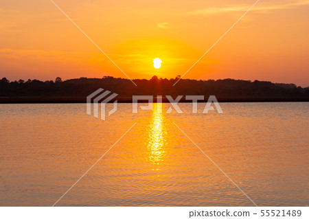 Sunset reflection lagoon. beautiful sunset behind 55521489
