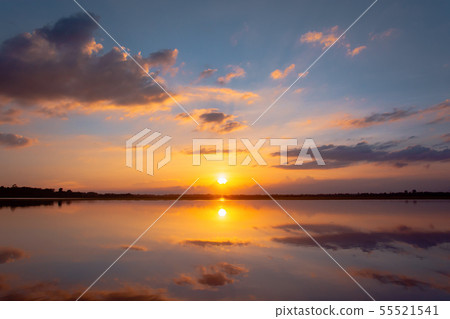 Sunset reflection lagoon. beautiful sunset behind 55521541