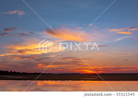 Sunset reflection lagoon. beautiful sunset behind 55521545