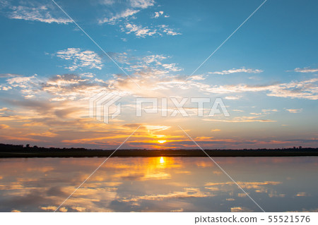 Sunset reflection lagoon. beautiful sunset behind 55521576