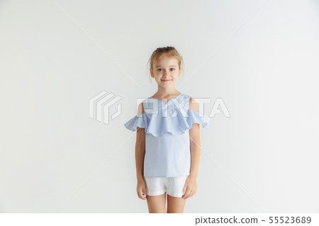 Little smiling girl posing in casual clothes on white studio background 55523689