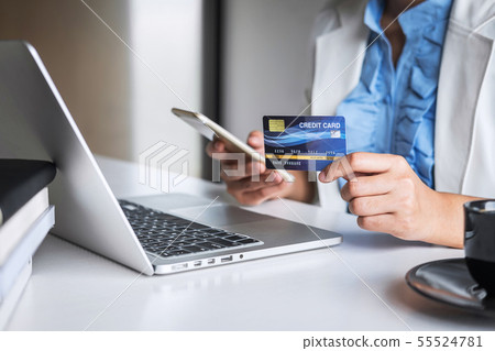 Young woman consumer holding smartphone, credit 55524781