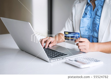 Business woman consumer holding credit card and 55524782