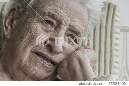 Closeup portrait of thoughtful senior woman 55525403