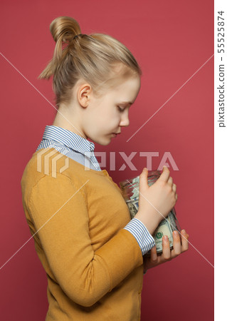 Cute teenager girl holding money cash in jar. 55525874