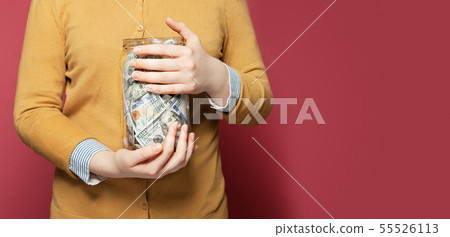 Jar full of money in hands. Saving money concept 55526113