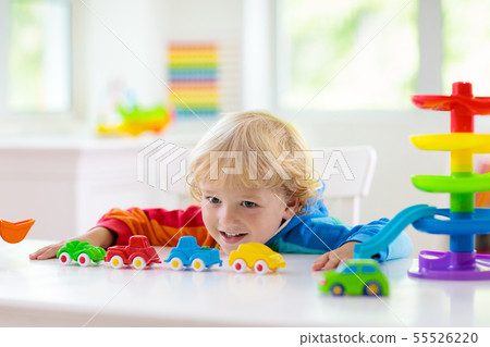 Boy playing toy cars. Kid with toys. Child and car Boy playing toy cars. Kid with toys. Child and car 55526220