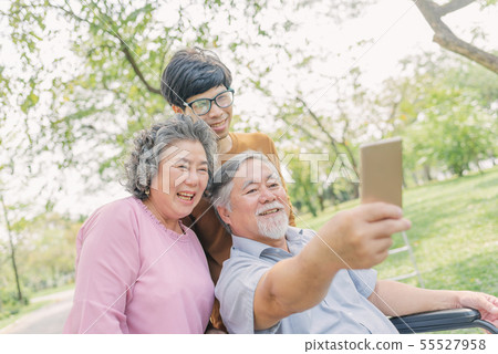 senior Asian man using smartphone for selfie with 55527958