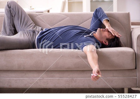 Young man having problems with narcotics at home 55528427