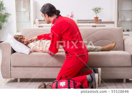 Young male paramedic visiting young woman 55528646
