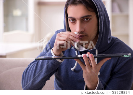 Young man having problems with narcotics at home Young man having problems with narcotics at home 55529854