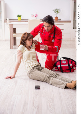 Young male paramedic visiting young woman Young male paramedic visiting young woman 55530860