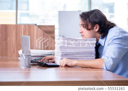 Young employee unhappy with excessive work 55531161