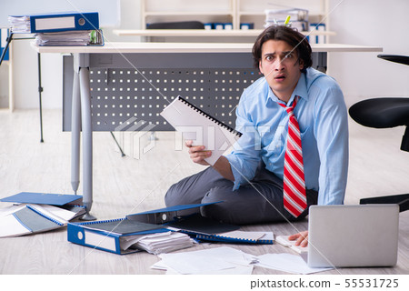Young male employee unhappy with excessive work 55531725