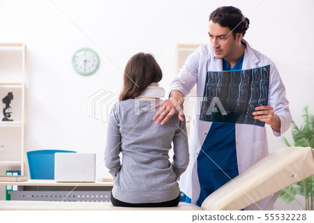 Young male doctor and female beautiful patient 55532228