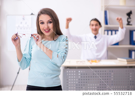 Young woman visiting male doctor oculist 55532718