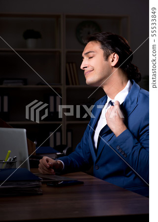 Young male employee working night in the office 55533849