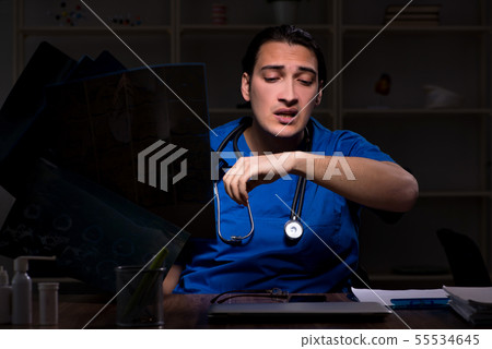 Young male doctor in the hospital at night Young male doctor in the hospital at night 55534645