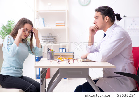 Young woman visiting male doctor oculist Young woman visiting male doctor oculist 55536254