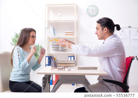 Young woman visiting male doctor oculist Young woman visiting male doctor oculist 55536777
