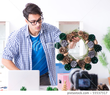 Young vlogger recording video doing christmas decoration Young vlogger recording video doing christmas decoration 55537317