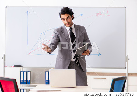 Young handsome businessman in front of whiteboard 55537786