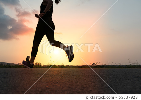 sport woman running on road during sunset sport woman running on road during sunset 55537928