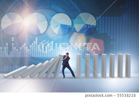 Businessman preventing domino effect in business concept Businessman preventing domino effect in business concept 55538218