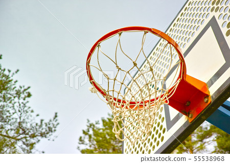 An old basketball hoop and net, with the sky as An old basketball hoop and net, with the sky as 55538968