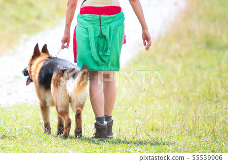 Detail of a woman with her German shepherd dog Detail of a woman with her German shepherd dog 55539906