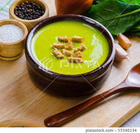Spinach soup served on wooden board Spinach soup served on wooden board 55540134