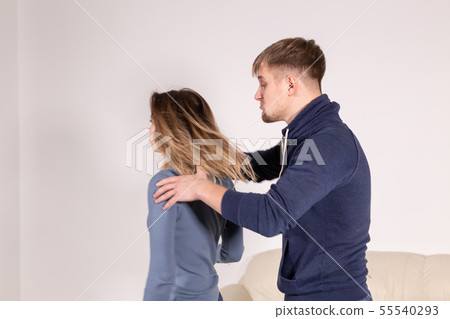People, abuse and domestic violence concept - Portrait of man beating woman at home 55540293