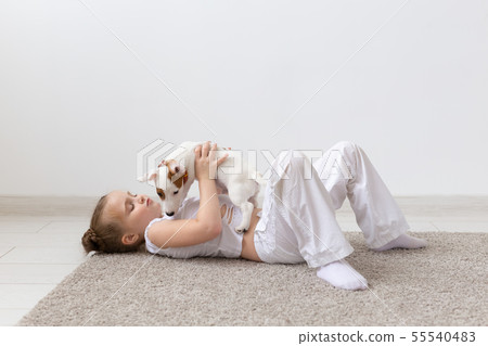 Pets and animal concept - Child girl playing with puppy Jack Russell Terrier Pets and animal concept - Child girl playing with puppy Jack Russell Terrier 55540483