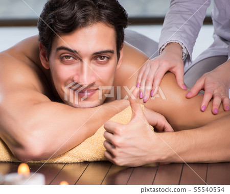 Young handsome man during spa procedure Young handsome man during spa procedure 55540554
