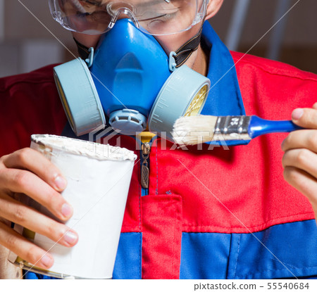 Young man gluing wood pieces together in DIY concept 55540684